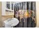 Bright bathroom with a modern sink and a unique, colorful rhino-themed shower curtain at 2867, 2851 Nc-210 & Galilee Hwy, Smithfield, NC 27577