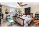 This bedroom features a bed with floral comforter, a ceiling fan, and natural light from a window at 2867, 2851 Nc-210 & Galilee Hwy, Smithfield, NC 27577