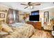 Cozy bedroom featuring a ceiling fan, floral bedding, and a large TV for relaxing evenings at 2867, 2851 Nc-210 & Galilee Hwy, Smithfield, NC 27577