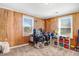 Bedroom features a window for natural light, wooden walls, and ample space at 2867, 2851 Nc-210 & Galilee Hwy, Smithfield, NC 27577