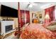 Comfortable bedroom with a cozy fireplace, four-poster bed, and large screen TV at 2867, 2851 Nc-210 & Galilee Hwy, Smithfield, NC 27577