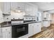 Traditional kitchen featuring white cabinets, black countertop, and tile backsplash at 2867, 2851 Nc-210 & Galilee Hwy, Smithfield, NC 27577