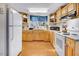 Bright kitchen featuring wood cabinets, modern appliances, and hardwood flooring at 2867, 2851 Nc-210 & Galilee Hwy, Smithfield, NC 27577