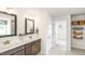 Bathroom with double sinks, granite countertops, and a view into the walk-in closet at 302 Umstead St, Sanford, NC 27330