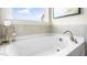 Close up on soaking tub with a view to the outdoors at 302 Umstead St, Sanford, NC 27330
