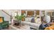 Inviting living room featuring a comfortable sofa, stylish decor, and an open view to the modern kitchen at 302 Umstead St, Sanford, NC 27330