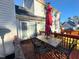 Enjoy outdoor dining on this deck complete with an umbrella-covered table and seating, conveniently located next to sliding glass doors at 401 Maymount Dr, Durham, NC 27703