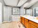 Well-lit bathroom featuring a double vanity, soaking tub, and glass-enclosed shower at 401 Maymount Dr, Durham, NC 27703