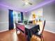 Inviting dining area with wood floors, a large window, and a view into the kitchen at 401 Maymount Dr, Durham, NC 27703