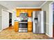 Bright kitchen featuring stainless steel appliances, wooden cabinets, and a modern refrigerator at 401 Maymount Dr, Durham, NC 27703