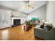 Comfortable living room with a cozy fireplace, hardwood floors, and natural light at 401 Maymount Dr, Durham, NC 27703