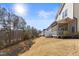 View of backyard featuring a screened-in porch, mature trees, and an expansive grassy area at 415 Mariah Towns Way, Garner, NC 27529