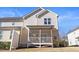 Rear of house featuring a screened-in porch and an attached deck and well-kept yard at 415 Mariah Towns Way, Garner, NC 27529