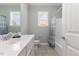 Clean bathroom with white cabinets, grey tile floor, and a shower/tub combination at 415 Mariah Towns Way, Garner, NC 27529