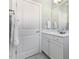 Clean bathroom featuring a white vanity with storage and a framed mirror at 415 Mariah Towns Way, Garner, NC 27529