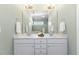 Bathroom featuring a double sink vanity, mirror, modern fixtures and neutral decor at 415 Mariah Towns Way, Garner, NC 27529