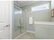 Modern bathroom featuring a glass-enclosed shower and a narrow horizontal window for natural light at 415 Mariah Towns Way, Garner, NC 27529
