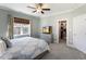 Primary bedroom featuring a ceiling fan, window, closet, carpet flooring and neutral decor at 415 Mariah Towns Way, Garner, NC 27529
