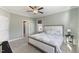 Bedroom featuring a ceiling fan, carpet flooring, two windows, and neutral decor at 415 Mariah Towns Way, Garner, NC 27529