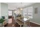 Dining room with hardwood floors, bench seating, modern lighting, and large windows at 415 Mariah Towns Way, Garner, NC 27529
