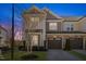 Charming two-story townhome with a stone and siding exterior, two car garage, and well maintained landscaping at 415 Mariah Towns Way, Garner, NC 27529