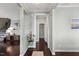 Inviting foyer with hardwood floors, neutral walls, staircase, decorative plants, and modern lighting at 415 Mariah Towns Way, Garner, NC 27529