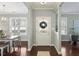 Foyer with beautiful hardwood floors, view of front door, view of dining room, and gray walls at 415 Mariah Towns Way, Garner, NC 27529