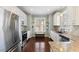 Modern kitchen featuring stainless steel appliances, granite countertops, and white cabinetry at 415 Mariah Towns Way, Garner, NC 27529