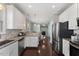 Bright kitchen with stainless steel appliances, granite counters and abundant white cabinetry at 415 Mariah Towns Way, Garner, NC 27529