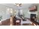 Bright living room with fireplace, ceiling fan, hardwood floors and an open floor plan at 415 Mariah Towns Way, Garner, NC 27529