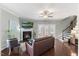 Cozy living room with fireplace, ceiling fan, hardwood floors and access to the outdoor space at 415 Mariah Towns Way, Garner, NC 27529
