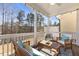 Relaxing screened porch with comfortable seating and a view of the wooded landscape at 415 Mariah Towns Way, Garner, NC 27529