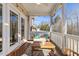 Inviting screened porch with outdoor furniture perfect for enjoying the serene natural scenery at 415 Mariah Towns Way, Garner, NC 27529