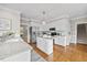 Bright kitchen with white cabinets, granite countertops, and stainless steel appliances at 4209 Omni Pl, Raleigh, NC 27613