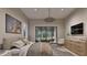 A bedroom with a view, with soft lighting and a decorative dresser at 4308 Windsor Pl, Raleigh, NC 27609