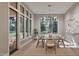 Bright dining room with modern chandelier, large windows, and seating for six, perfect for entertaining at 4308 Windsor Pl, Raleigh, NC 27609