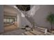 Bright foyer featuring a staircase with black iron railing, wood steps, and accents, with hardwood floors and elegant decor at 4308 Windsor Pl, Raleigh, NC 27609