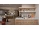 Modern kitchen featuring stainless steel appliances, a large center island with seating, and a seamless transition to the living area at 4308 Windsor Pl, Raleigh, NC 27609