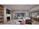 Open living room featuring a fireplace, built-in bookshelves, modern furniture, and a sliding glass door to the patio at 4308 Windsor Pl, Raleigh, NC 27609