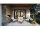 Inviting outdoor living space with a stone fireplace and cozy seating arrangement at 4308 Windsor Pl, Raleigh, NC 27609