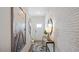 Inviting entryway featuring stylish decor, light hardwood flooring, and white brick accent wall at 434 Belgian Red Way, Wake Forest, NC 27587