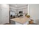 Modern kitchen with stainless steel appliances, granite countertops, and light gray cabinetry at 434 Belgian Red Way, Wake Forest, NC 27587