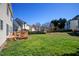 Spacious backyard featuring a well-maintained lawn and a wooden deck, perfect for outdoor entertaining at 5008 Casland Dr, Raleigh, NC 27604