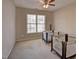Bedroom features two cribs, neutral walls, carpet, and a window at 5008 Casland Dr, Raleigh, NC 27604