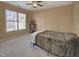 Cozy bedroom with neutral walls, carpet, and plenty of natural light from the large window at 5008 Casland Dr, Raleigh, NC 27604