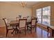 Formal dining room featuring hardwood floors, a chandelier, and bright windows at 5008 Casland Dr, Raleigh, NC 27604