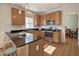 Kitchen with black countertops and stainless appliances, including an island with seating, offers a modern, stylish space at 5008 Casland Dr, Raleigh, NC 27604