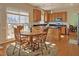 Eat-in kitchen features hardwood floors, black countertops, stainless appliances and lots of natural light at 5008 Casland Dr, Raleigh, NC 27604
