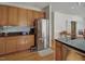 Beautiful kitchen area, featuring a stainless steel refrigerator and black countertops, blending style and functionality seamlessly at 5008 Casland Dr, Raleigh, NC 27604