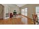 Bright living room with a fireplace, piano, and hardwood floors at 5008 Casland Dr, Raleigh, NC 27604